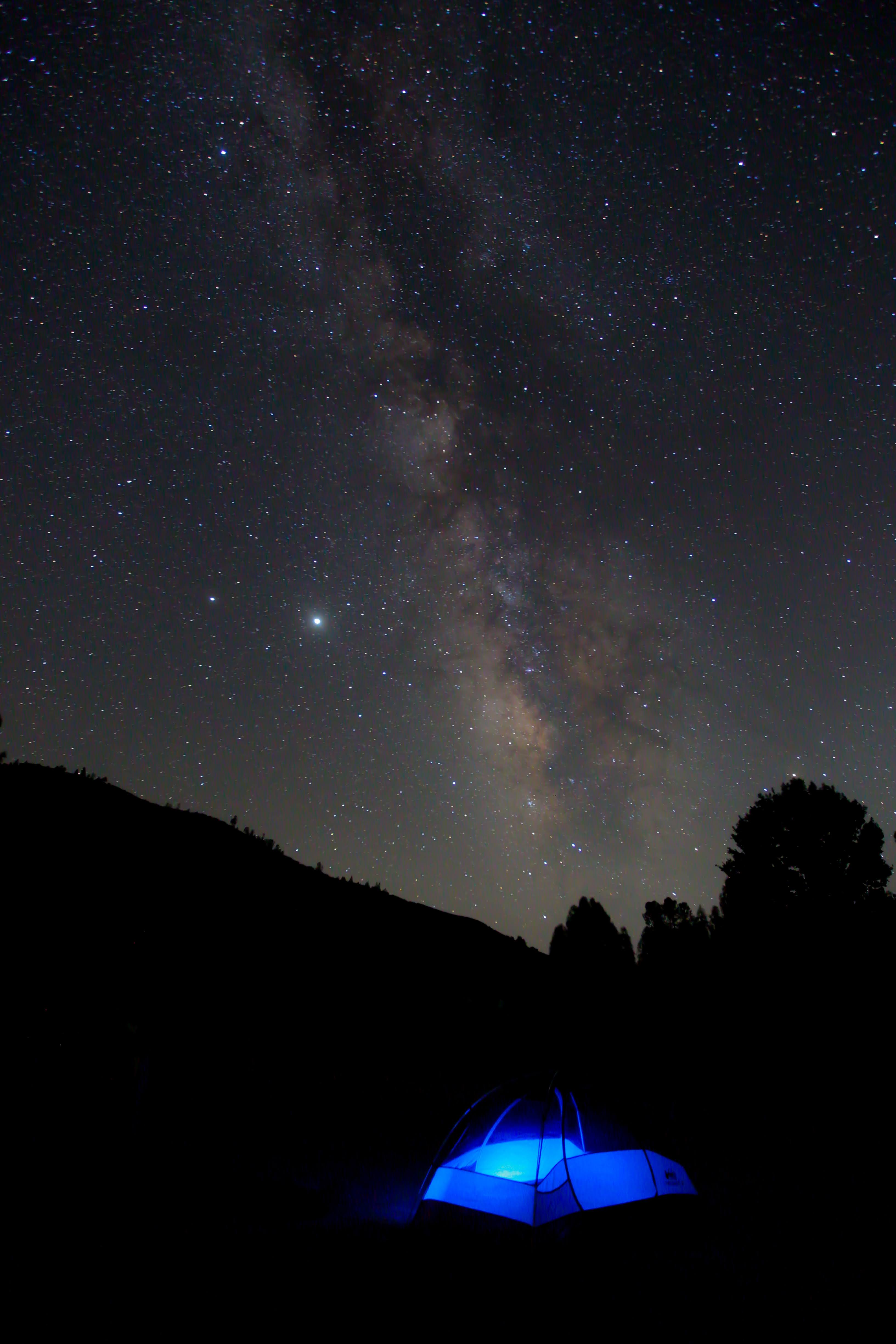 Glowing tent under the Milky Way